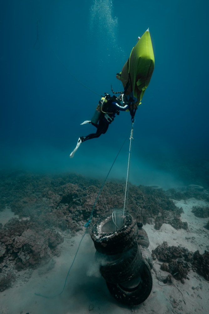 removing a large bundle of tires from the ocean